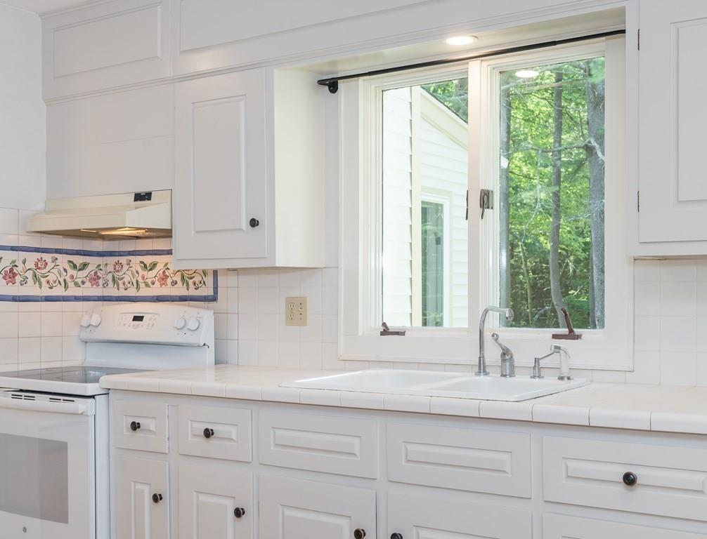 126 Brickyard Road Southampton, MA 01073 - Photo 18 of 41 a kitchen with granite countertop white cabinets and a window