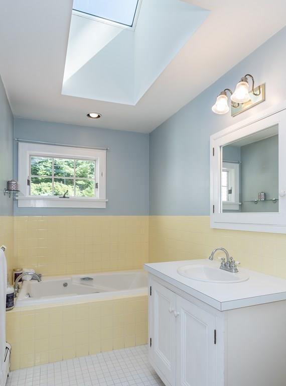 126 Brickyard Road Southampton, MA 01073 - Photo 24 of 41 a bathroom with a bathtub a sink and a window