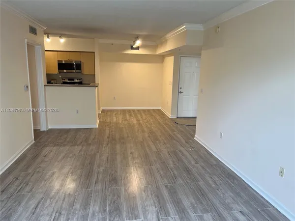 a view of a kitchen with wooden floor and a sink
