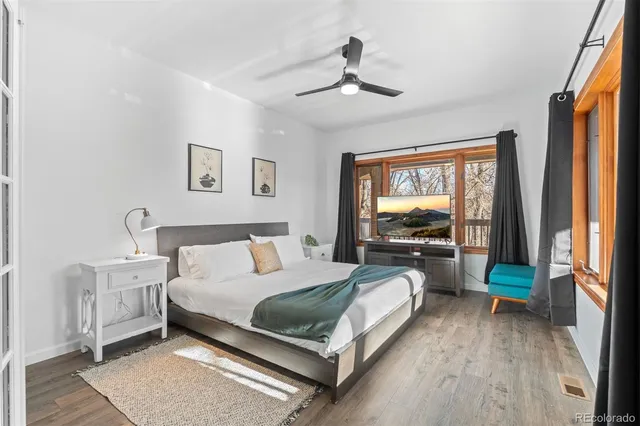 a bedroom with a bed and a large window