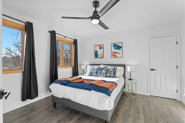 a bedroom with a bed and a painting on the wall