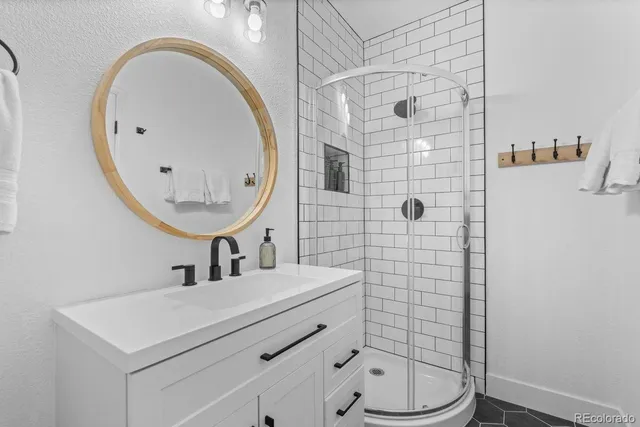 a bathroom with a sink mirror and toilet