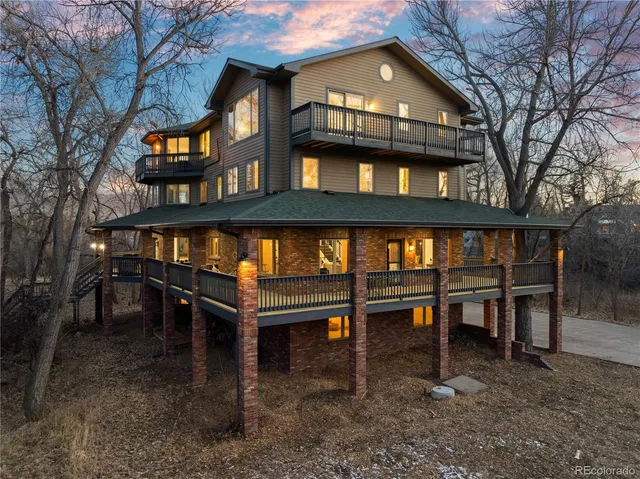 a front view of a house with a yard and wooden fence