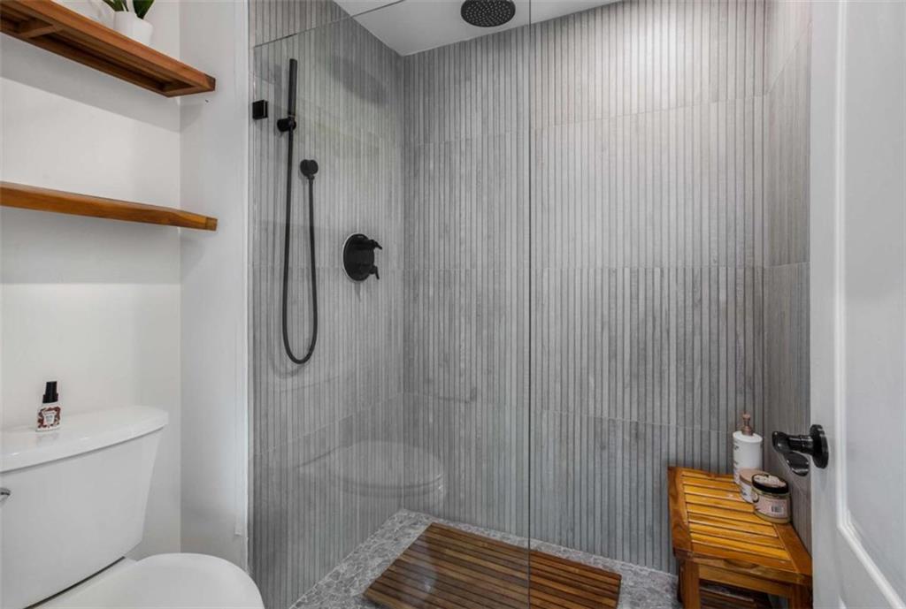 3475 Oak Valley Road Northeast, Unit 1630 Atlanta, GA 30326 - Photo 34 of 38 a bathroom with a shower and a toilet