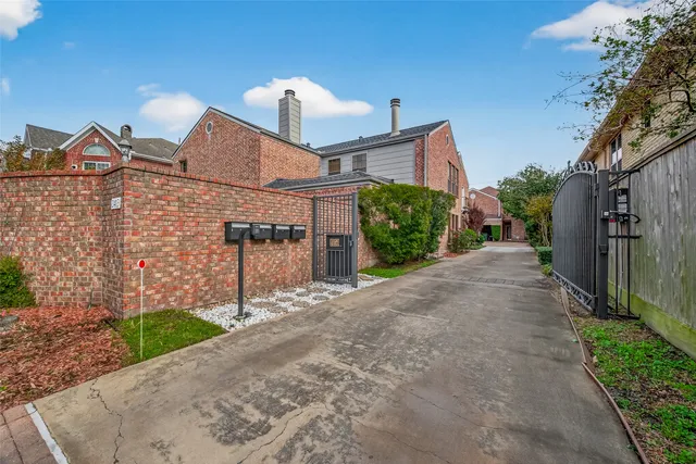 a view of a house with a yard and pathway