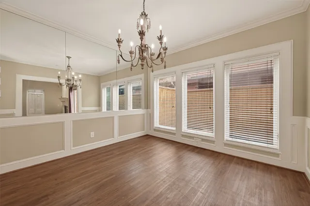 a view of livingroom with chandelier and wooden floor