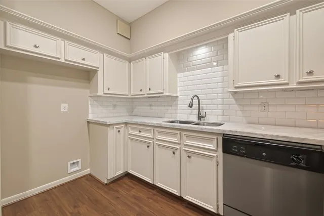 a kitchen with stainless steel appliances granite countertop a sink and dishwasher a stove a refrigerator with wooden cabinets