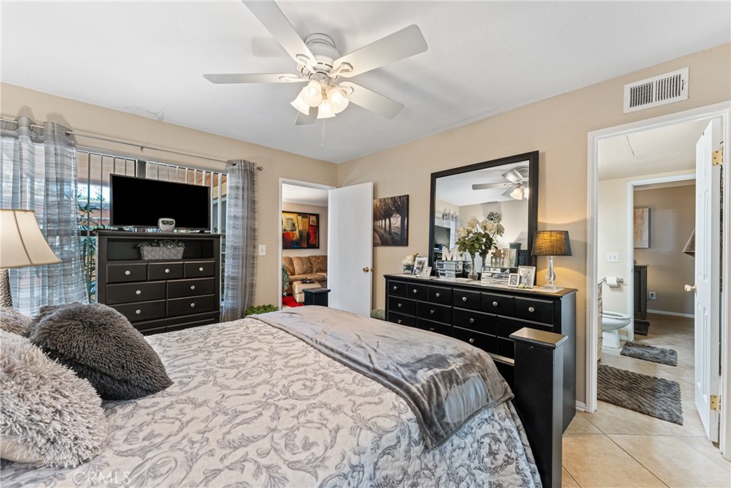 10655 Lemon Avenue Rancho Cucamonga, CA 91737 - Photo 16 of 32 a bedroom with a bed a mirror and a television