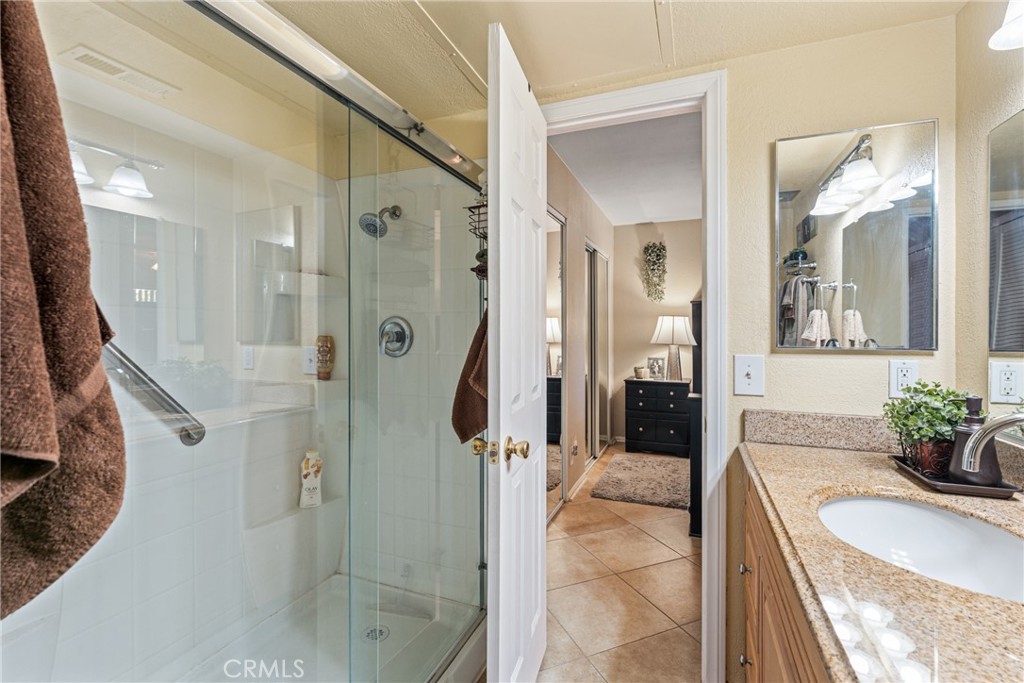 10655 Lemon Avenue Rancho Cucamonga, CA 91737 - Photo 19 of 32 a spacious bathroom with a granite countertop shower and a sink