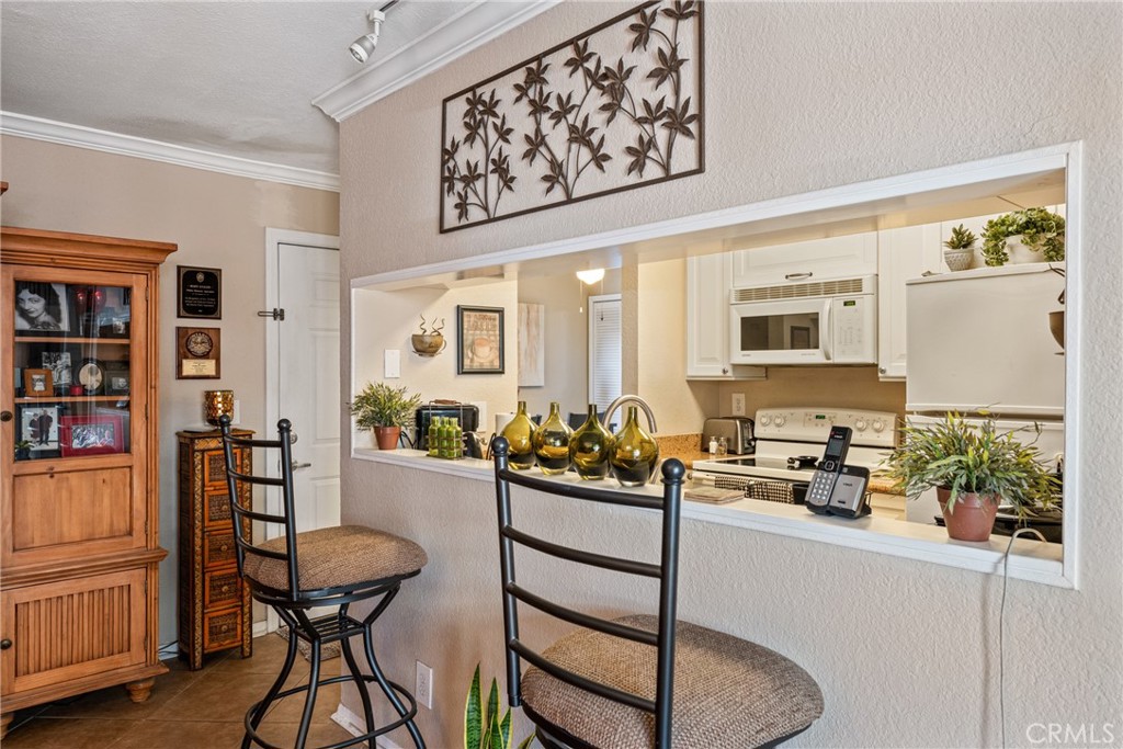 10655 Lemon Avenue Rancho Cucamonga, CA 91737 - Photo 7 of 32 a kitchen with stainless steel appliances white cabinets and wooden floor