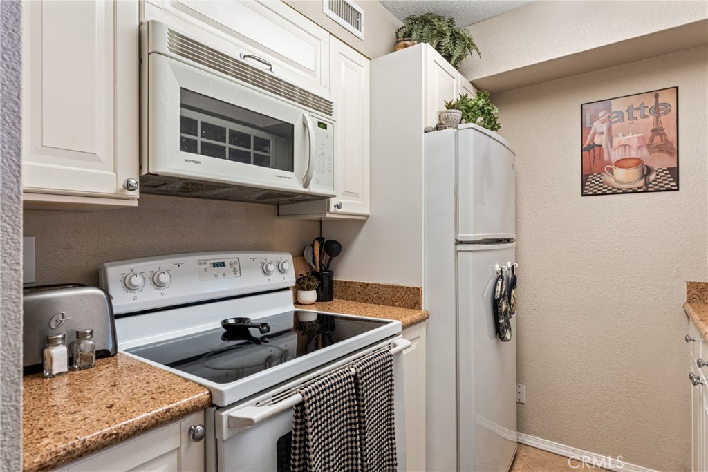 10655 Lemon Avenue Rancho Cucamonga, CA 91737 - Photo 10 of 32 a kitchen with stainless steel appliances granite countertop a sink stove and refrigerator