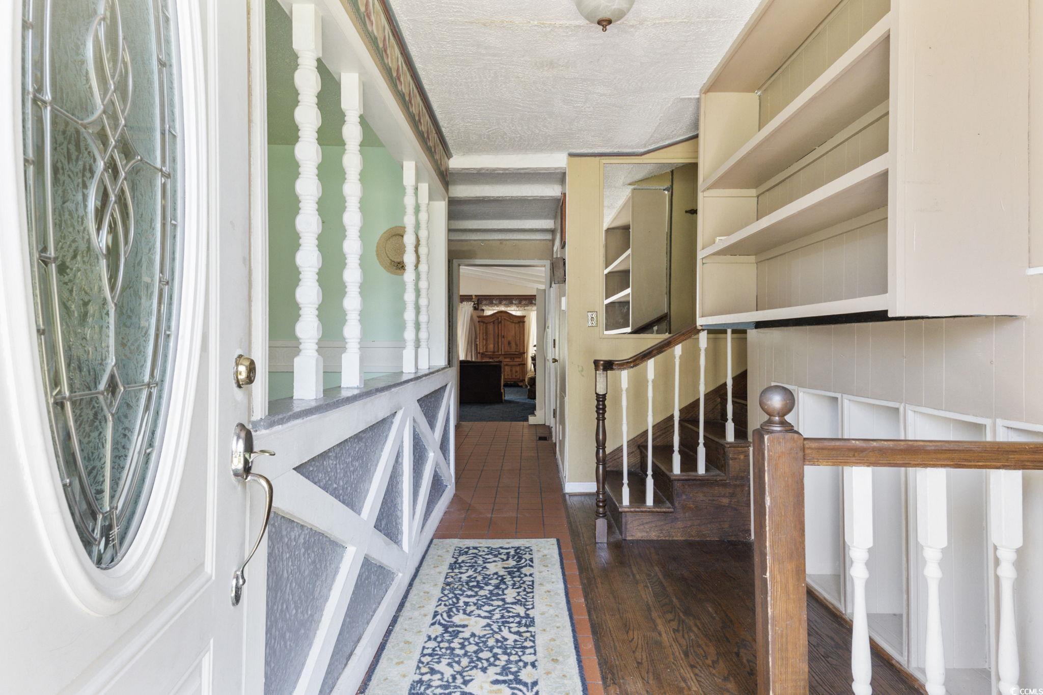 708 Charlotte Road Myrtle Beach, SC 29577 - Photo 2 of 40 Entryway featuring hardwood / wood-style flooring, stairway, and a textured ceiling