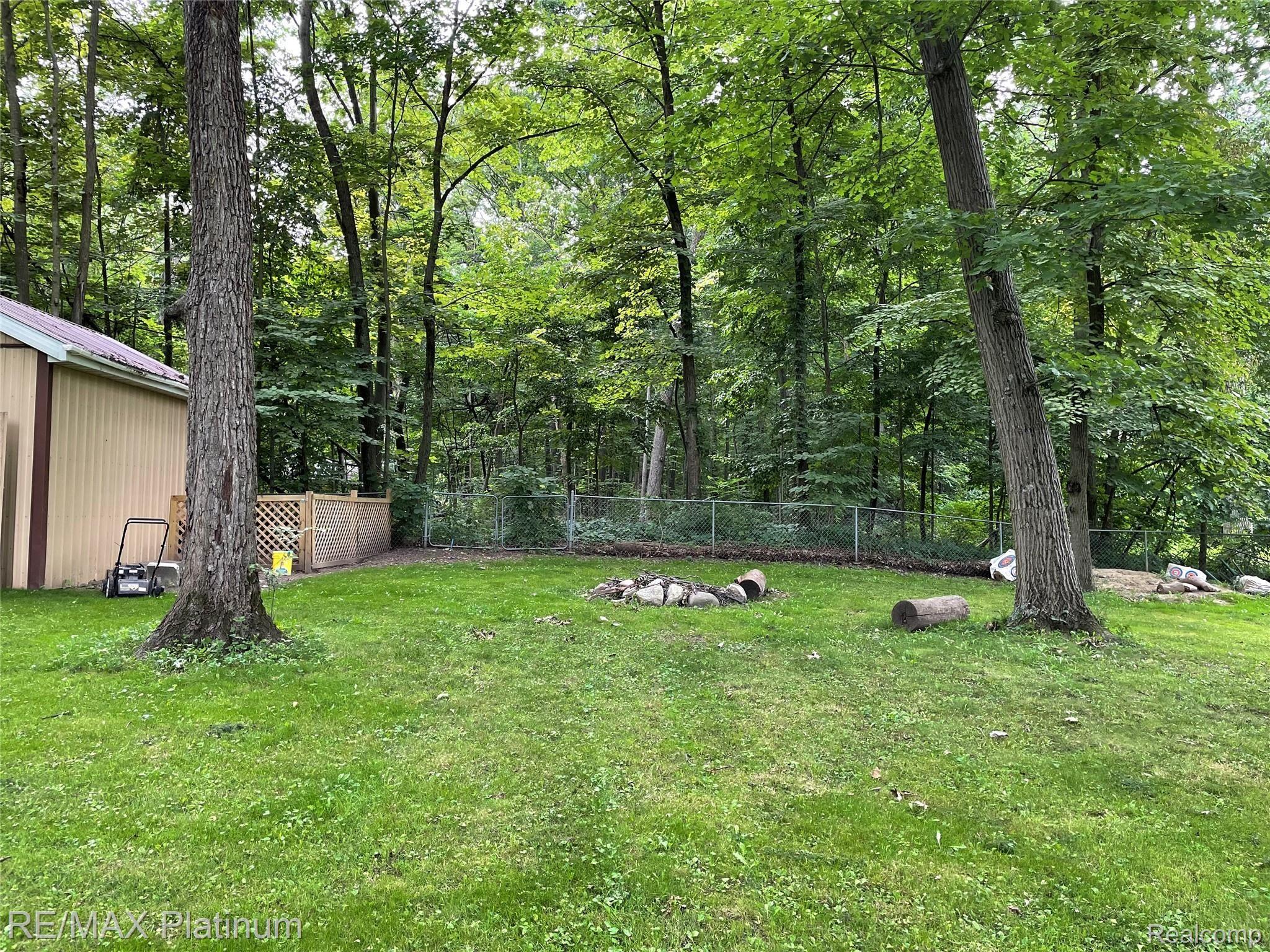 13204 Torrey Road Fenton, MI 48430 - Photo 21 of 24 Back Yard extends beyond the Fence into Wooded Area