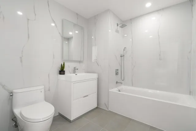 a bathroom with a toilet a sink and a bathtub