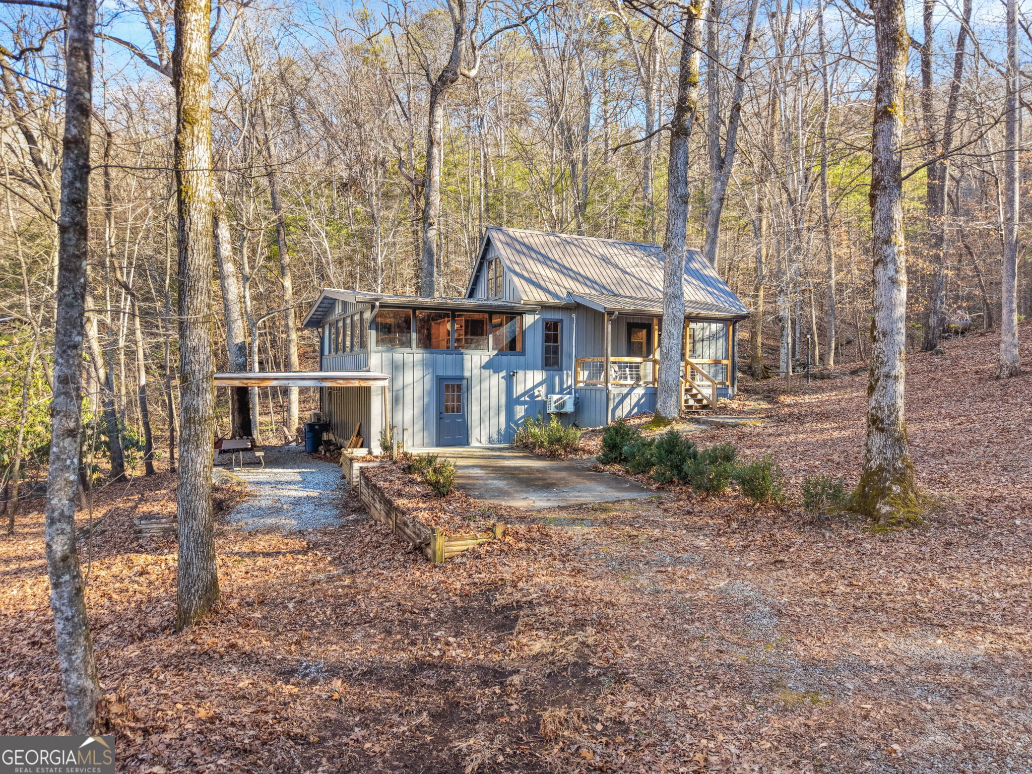 355 Henslee Hollow Lane Rabun Gap, GA 30568 - Photo 1 of 47 a view of a house with a yard covered in the forest