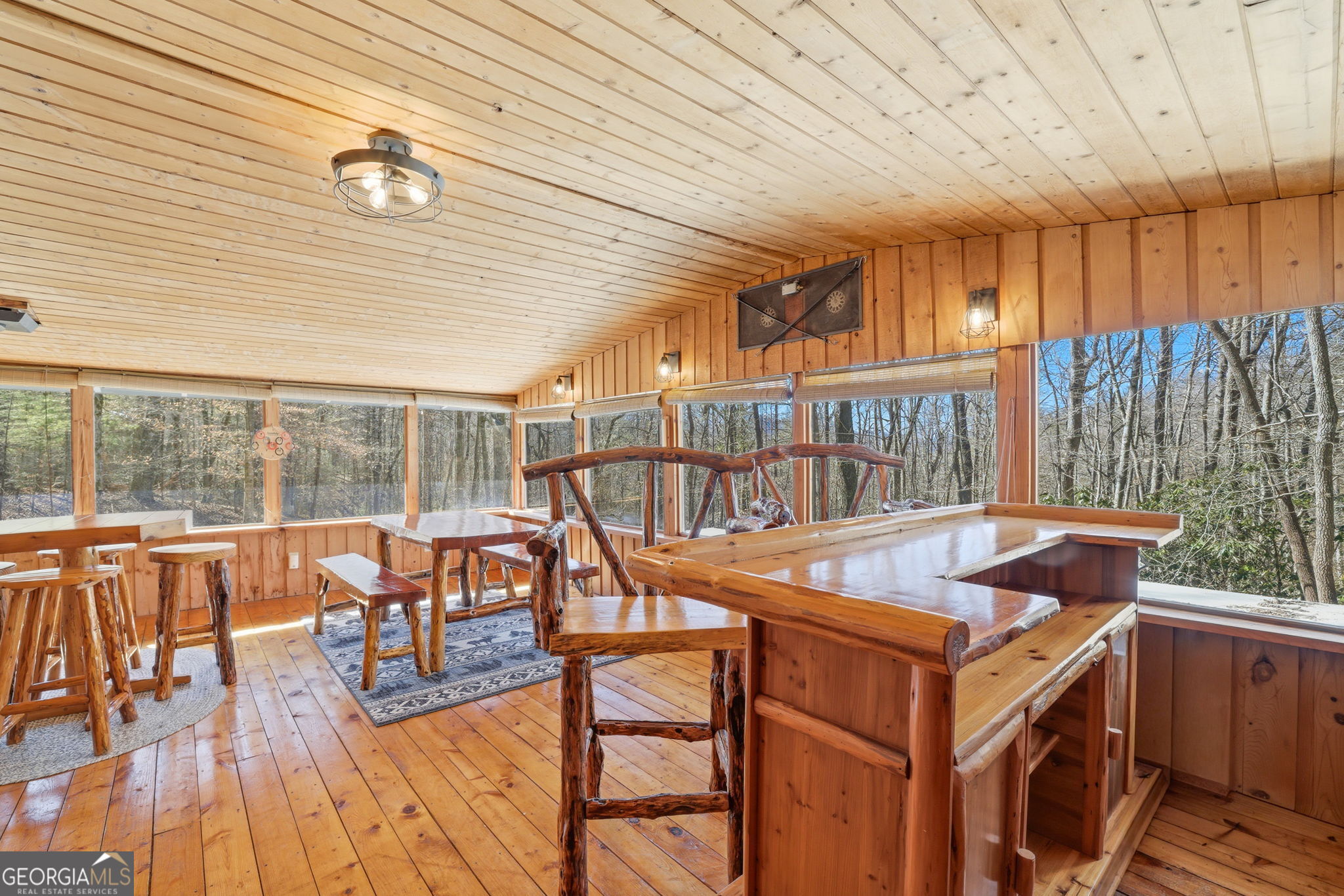 355 Henslee Hollow Lane Rabun Gap, GA 30568 - Photo 14 of 47 a view of a patio with a table chairs and wooden floor
