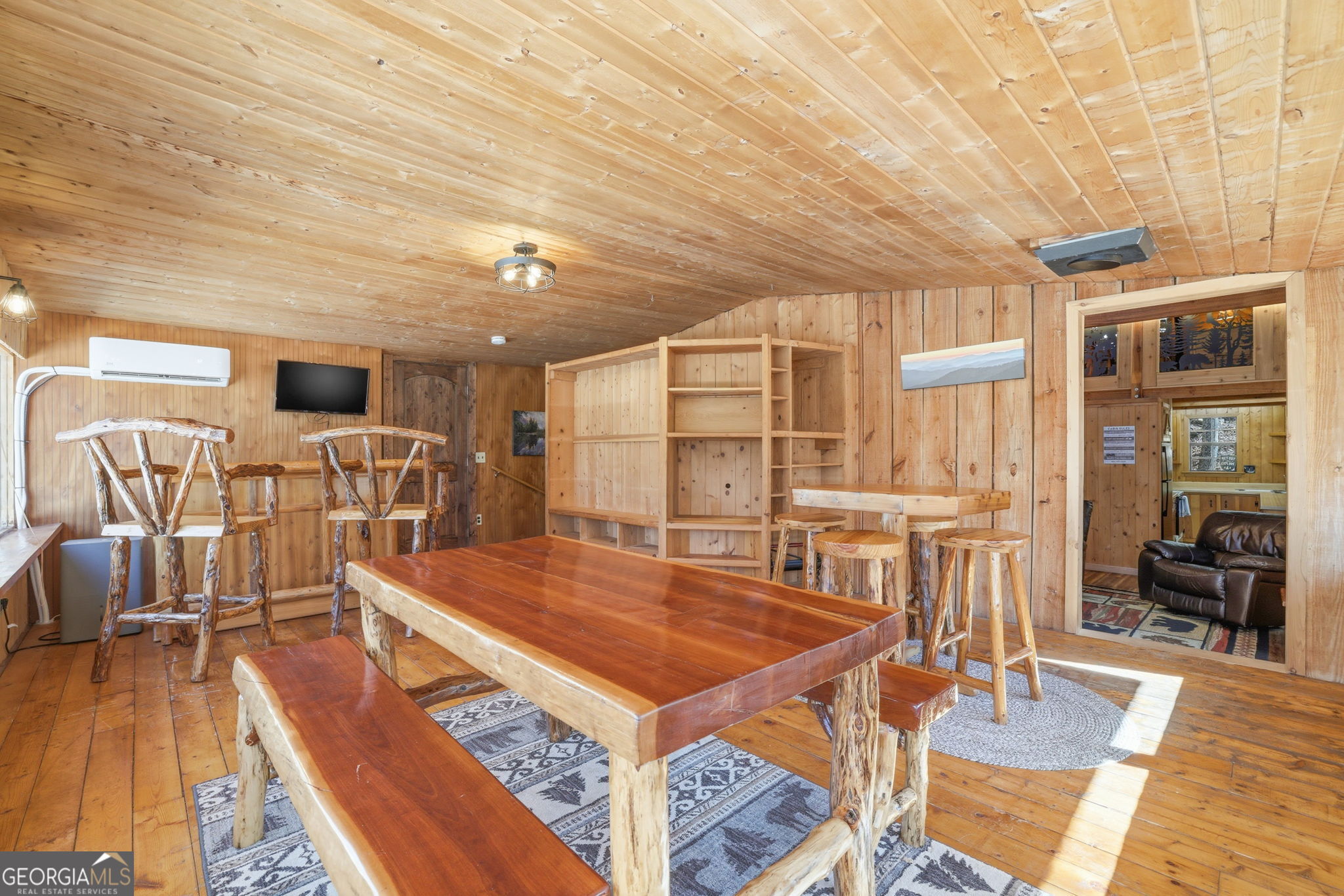 355 Henslee Hollow Lane Rabun Gap, GA 30568 - Photo 15 of 47 a living room with stainless steel appliances dining table a sink and wooden floor