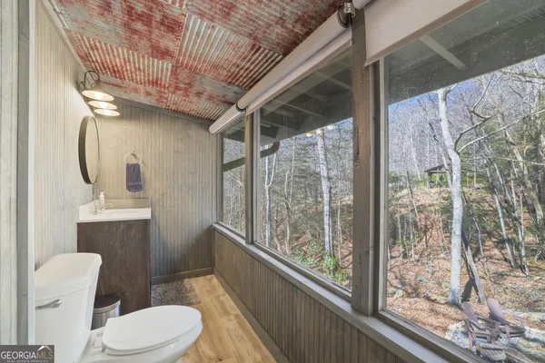 a bathroom with a toilet sink and shower