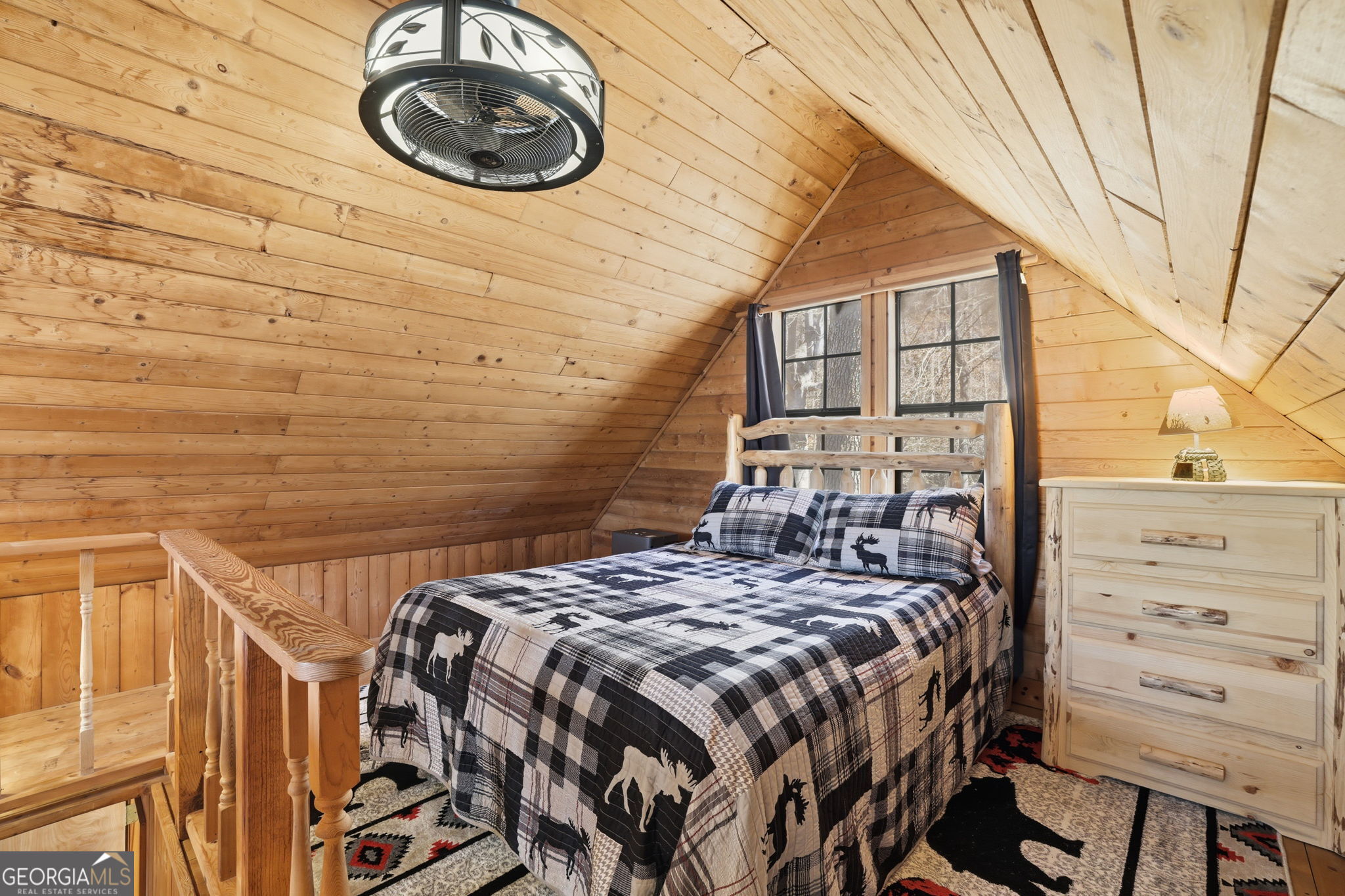 355 Henslee Hollow Lane Rabun Gap, GA 30568 - Photo 17 of 47 a bed sitting in a bedroom next to a window