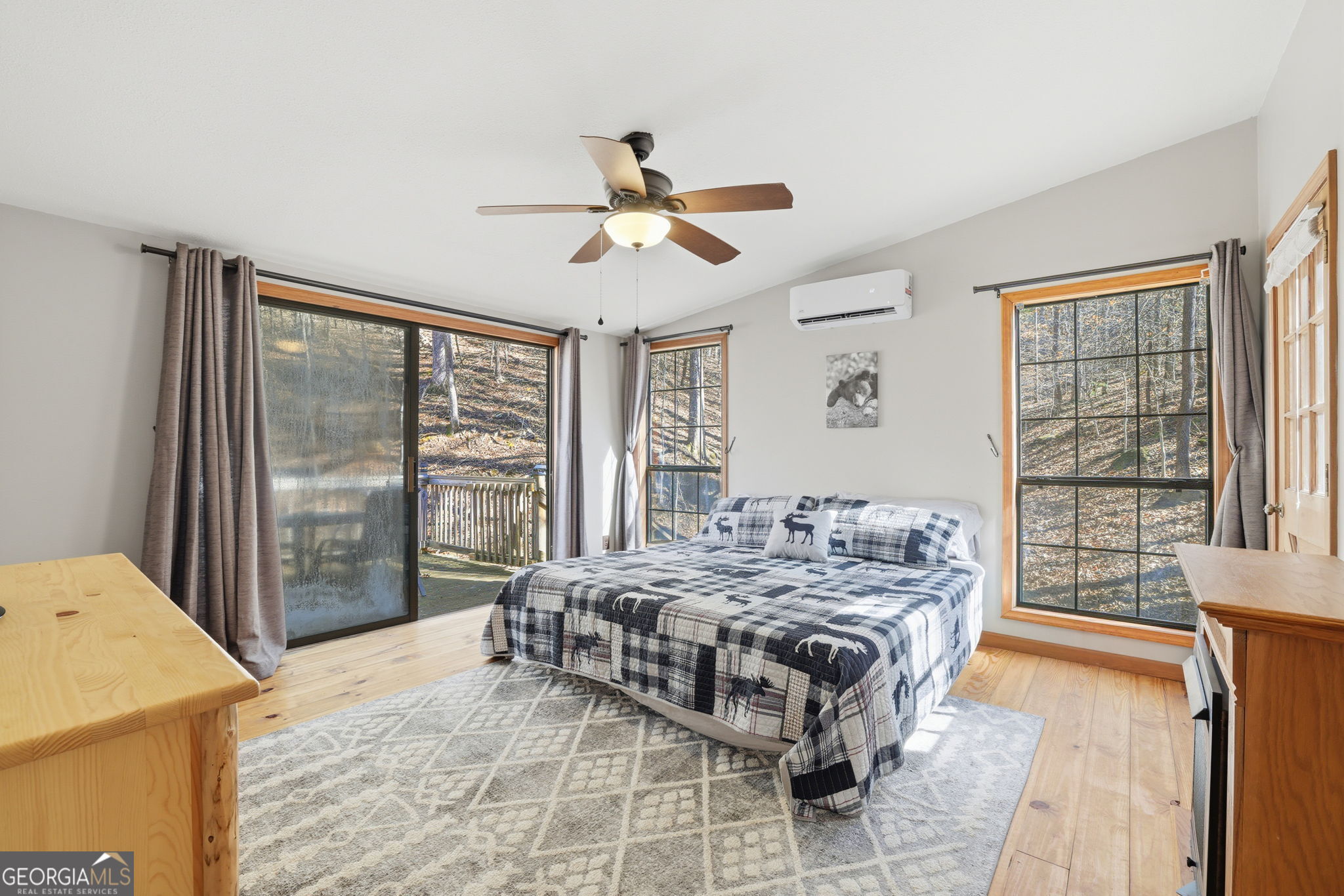 355 Henslee Hollow Lane Rabun Gap, GA 30568 - Photo 8 of 47 a bedroom with a bed and wooden floor