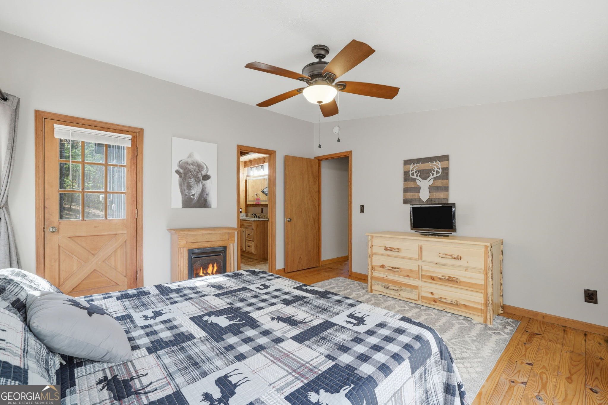 355 Henslee Hollow Lane Rabun Gap, GA 30568 - Photo 9 of 47 a bedroom with a bed and a chandelier