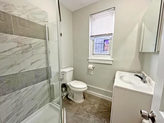 a bathroom with a sink toilet and shower
