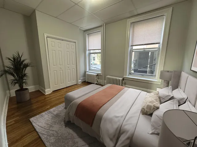 a bedroom with a bed and window