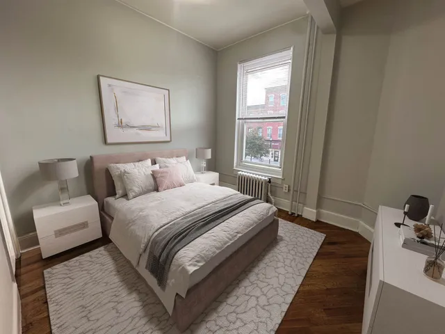 a bedroom with bed and a window