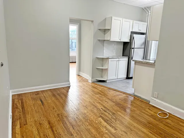 a view of kitchen with wooden floor and electronic appliances