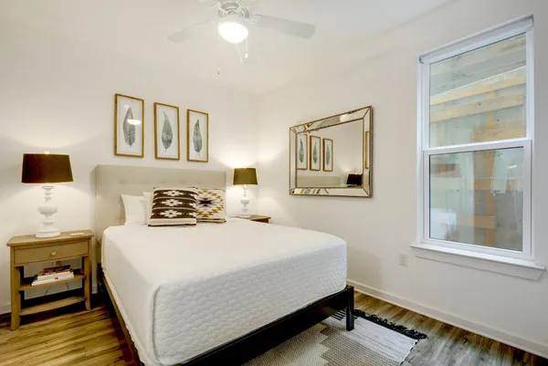 a bedroom with a bed and a window