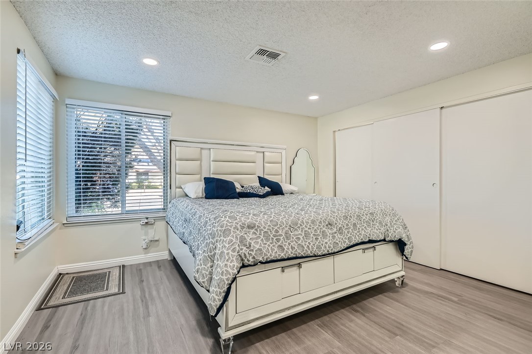 3665 Bronco Road Las Vegas, NV 89103 - Photo 13 of 28 Well-lit bedroom with modern flooring and integrated closet storage.