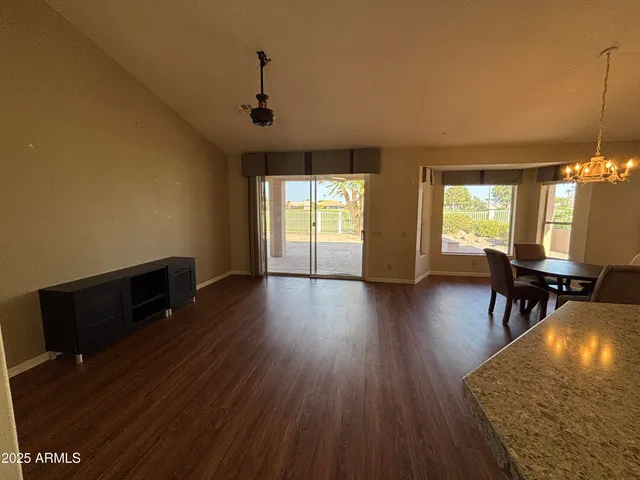 a living room with furniture wooden floor and a table