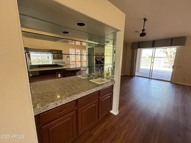 a kitchen with a wooden floor and a large window