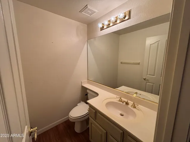 a bathroom with a sink a toilet and mirror