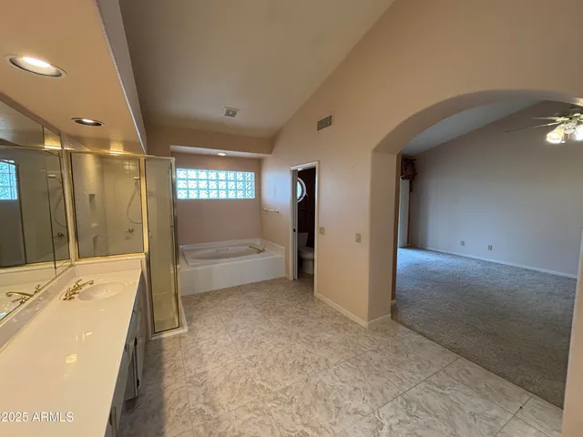 a bathroom with a tub shower and sink