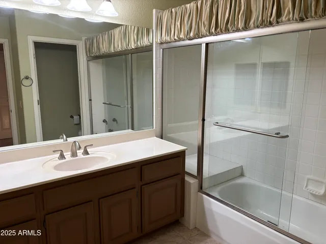 a bathroom with a sink and mirror