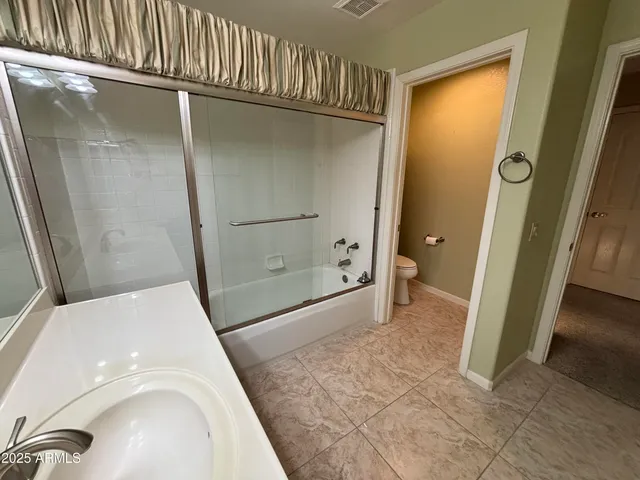 a bathroom with a sink and a glass door shower