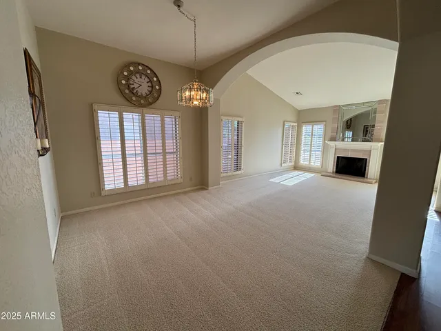 a view of an empty room with a fireplace