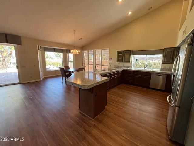 a kitchen with sink refrigerator and window