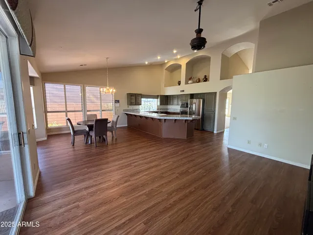 a view of dining room with furniture wooden floor and chandelier