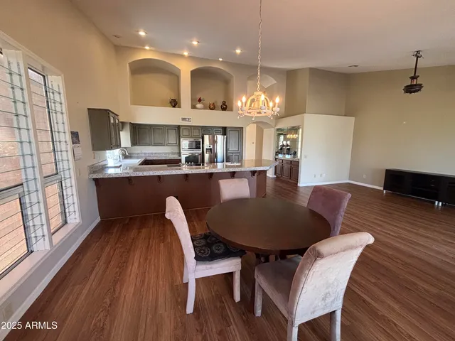a living room with kitchen island furniture and a chandelier