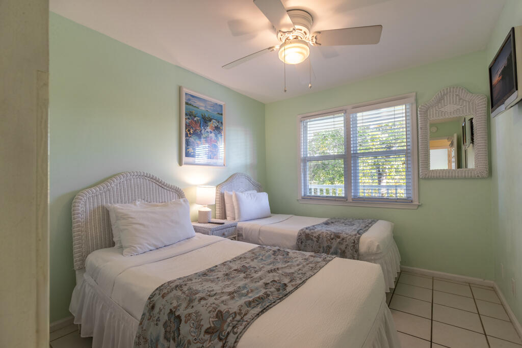 620 Thomas Street, Unit 291 Key West, FL 33040 - Photo 11 of 21 a bedroom with a large bed and a window