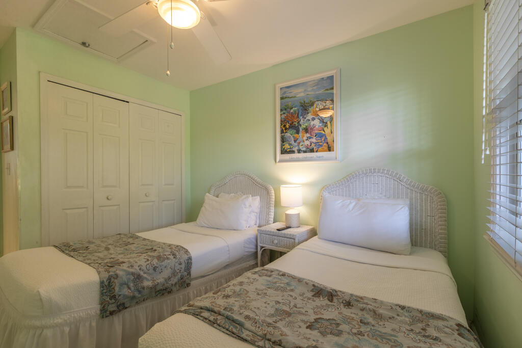 620 Thomas Street, Unit 291 Key West, FL 33040 - Photo 12 of 21 a bedroom with two beds and a painting on the wall