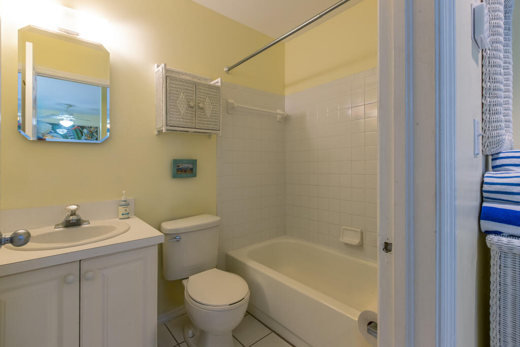 620 Thomas Street, Unit 291 Key West, FL 33040 - Photo 13 of 21 a bathroom with a sink a toilet and shower