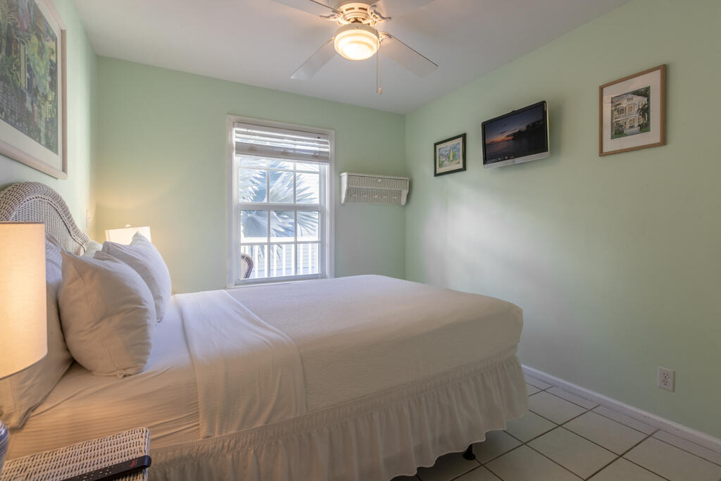 620 Thomas Street, Unit 291 Key West, FL 33040 - Photo 14 of 21 a bedroom with a bed and a window