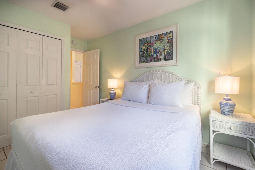 620 Thomas Street, Unit 291 Key West, FL 33040 - Photo 16 of 21 a bedroom with a bed and a table
