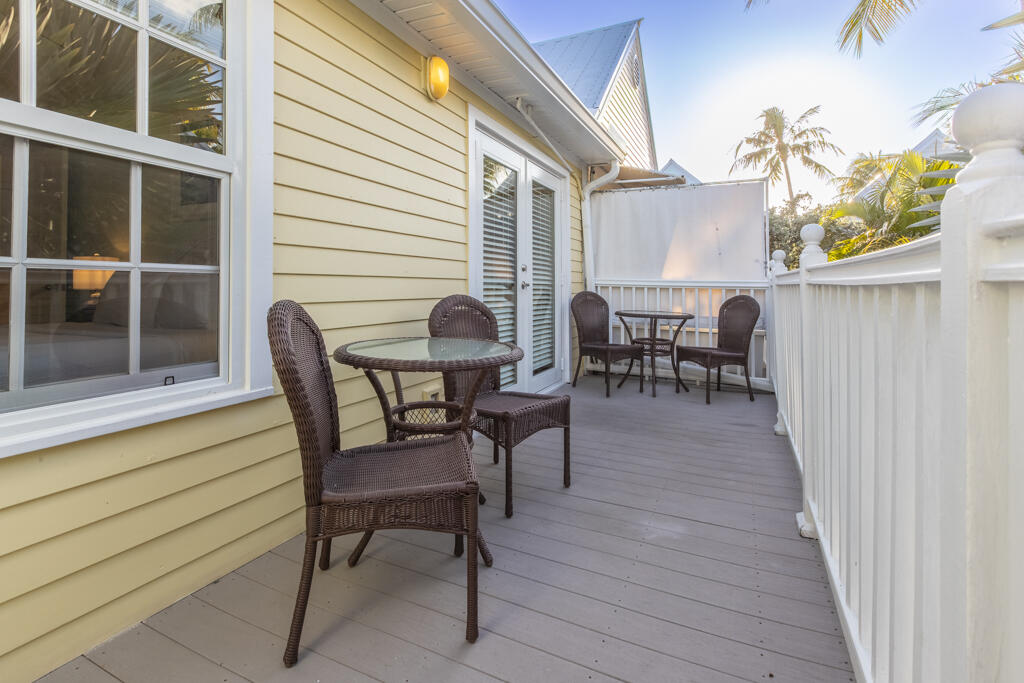 620 Thomas Street, Unit 291 Key West, FL 33040 - Photo 18 of 21 a view of a patio with table and chairs and wooden floor