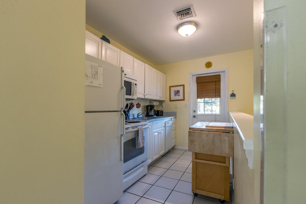 620 Thomas Street, Unit 291 Key West, FL 33040 - Photo 8 of 21 a kitchen with stainless steel appliances granite countertop a refrigerator a stove and a sink