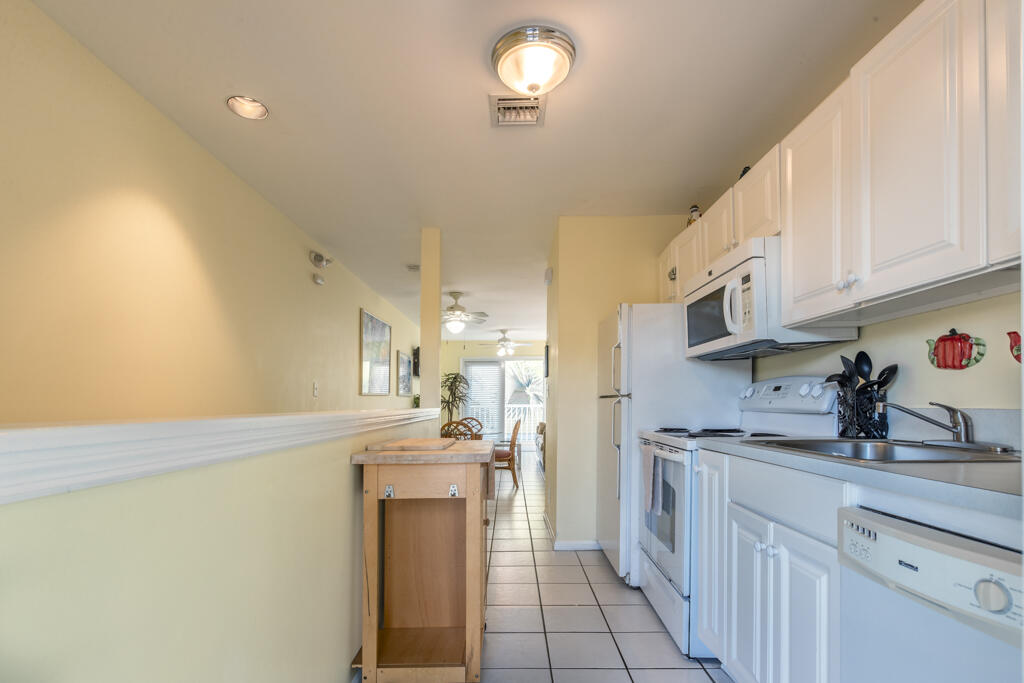 620 Thomas Street, Unit 291 Key West, FL 33040 - Photo 10 of 21 a kitchen with stainless steel appliances a sink stove and cabinets