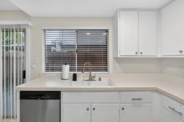 a kitchen with appliances a sink and cabinets